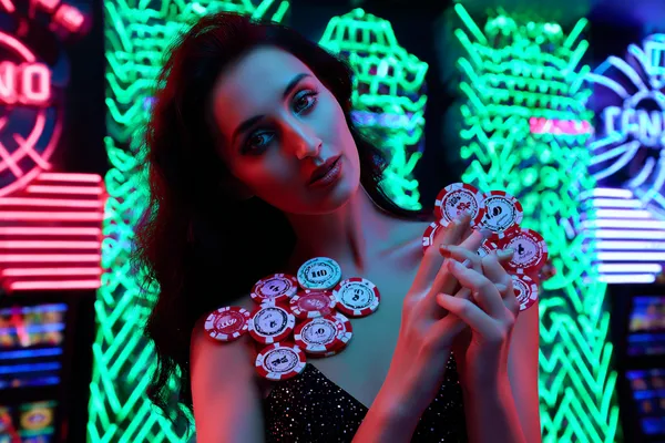 A stylish woman beside vibrant slot machines displaying glowing sevens, showcasing the variety of top slots at BB444.