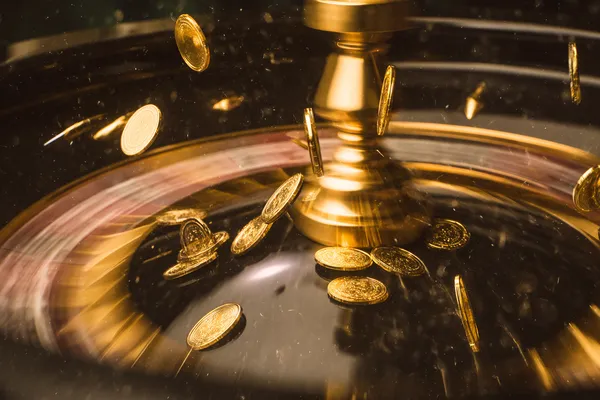 A woman smiling while playing online games on her laptop, surrounded by neon casino elements, showcasing BB444’s diverse game collection.
